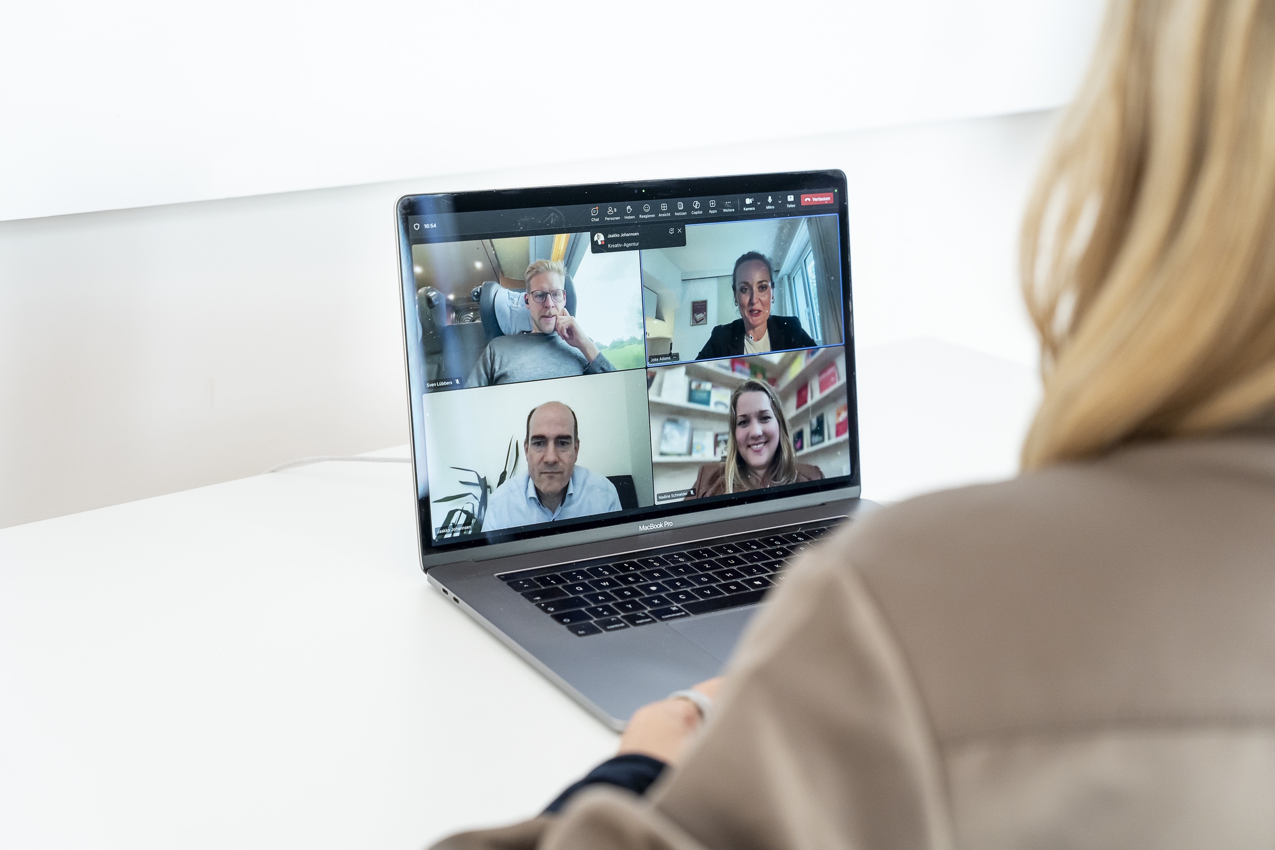 Person bei Videokonferenz am Laptop mit vier Teilnehmern